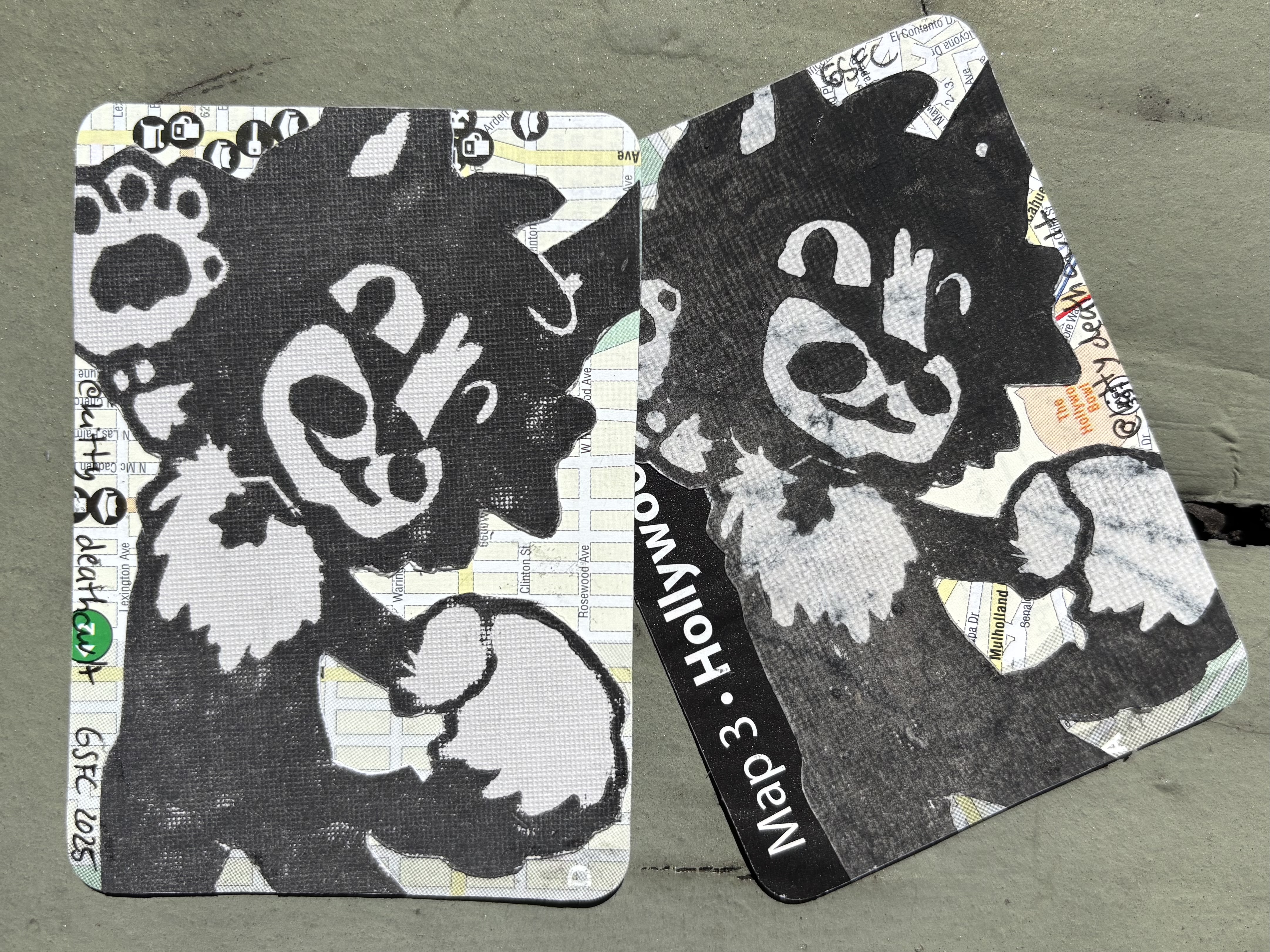 A photo of two 2.5in by 3.5in linocut block prints using the image above. They are printed on gray and marbled paper then collaged onto a map.